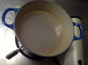 鍋にあさりの煮汁に水(米の分量の１．４倍ぐらい）を入れる