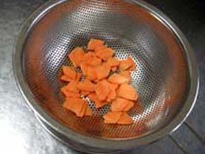 Cut the carrot into quarter-rounds and put it in the strainer